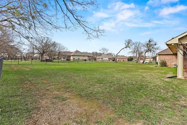 view of yard featuring a residential view and fence