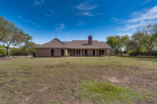 view of front of home with fence private yard, brick siding, and a front yard