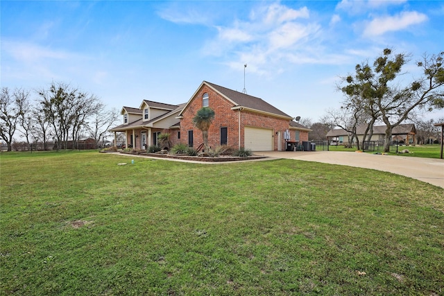 view of side of property featuring brick siding, a yard, an attached garage, fence, and driveway