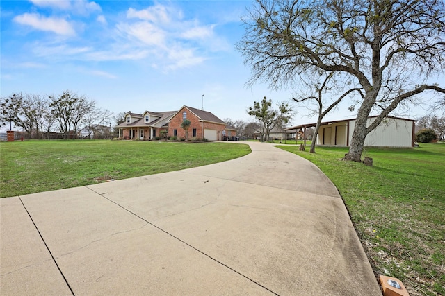 view of front of property with a garage, a front yard, and concrete driveway