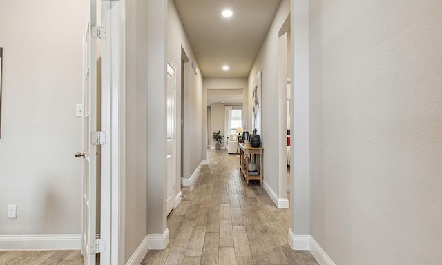 corridor with light hardwood / wood-style flooring