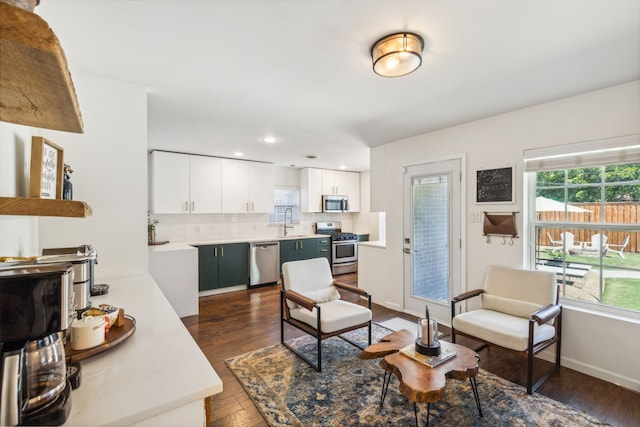 living room with sink and dark hardwood / wood-style floors