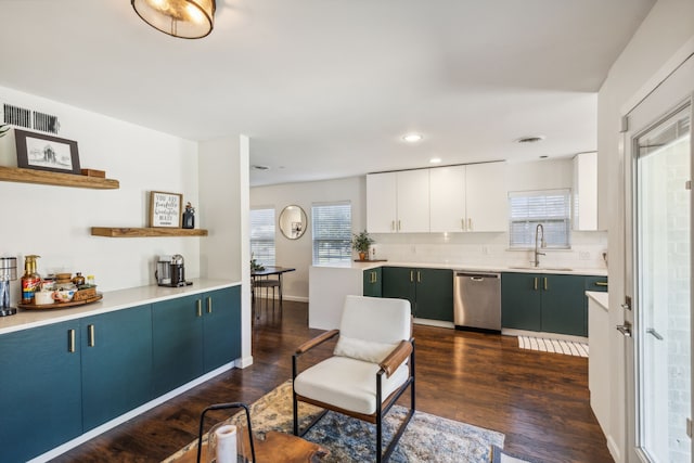 kitchen featuring sink, white cabinets, dishwasher, tasteful backsplash, and dark wood-type flooring