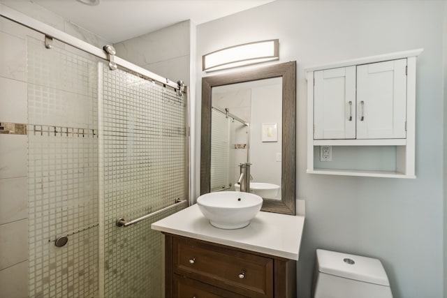 bathroom featuring walk in shower, vanity, and toilet