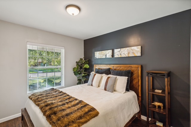 bedroom with dark hardwood / wood-style floors