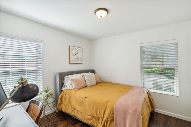 bedroom with dark hardwood / wood-style floors