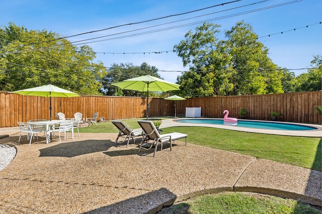 view of patio with a fenced in pool