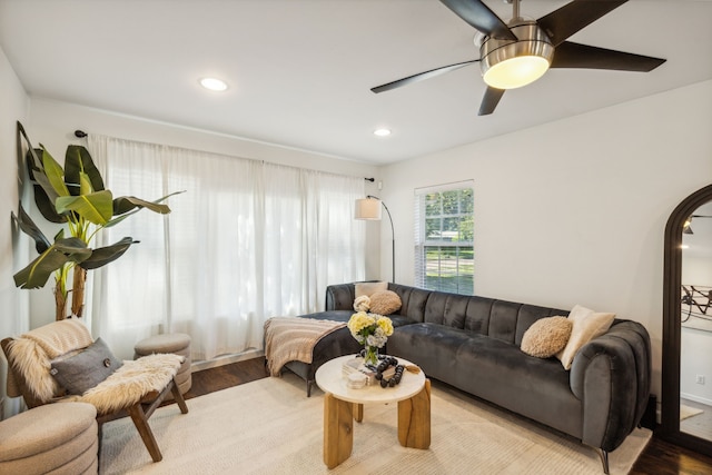 living room featuring ceiling fan and light hardwood / wood-style flooring