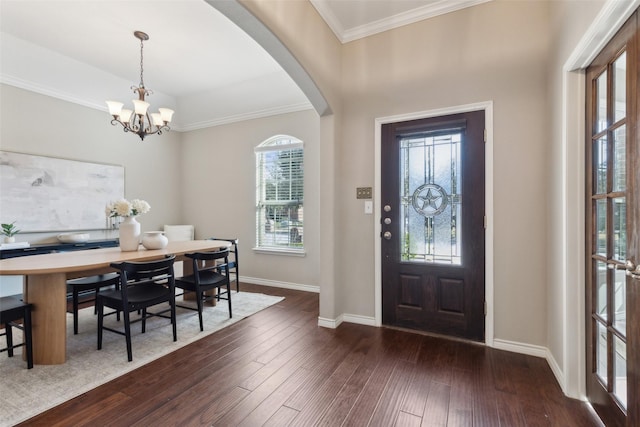 foyer with a chandelier, ornamental molding, and dark hardwood / wood-style floors