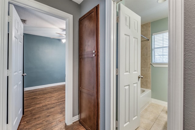 hall featuring light tile patterned flooring