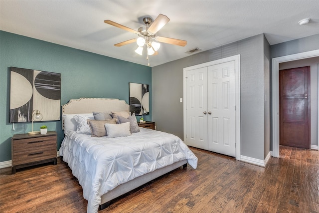 bedroom with ceiling fan, dark hardwood / wood-style flooring, and a closet