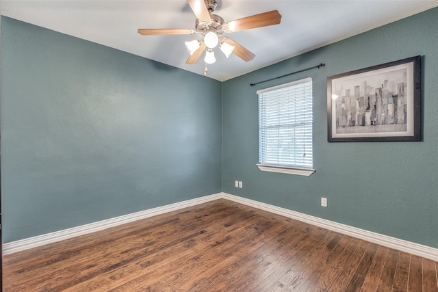 spare room with hardwood / wood-style floors and ceiling fan