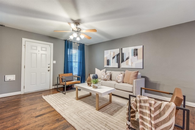 living room featuring ceiling fan and hardwood / wood-style flooring