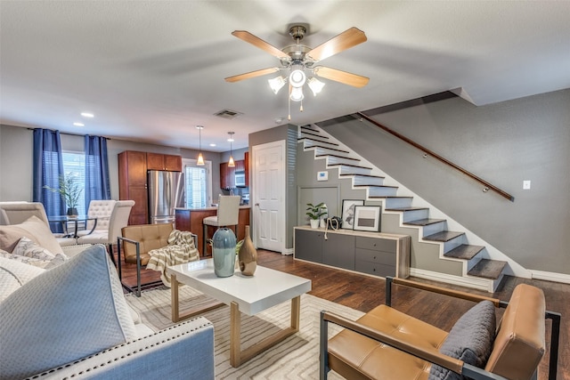 living room featuring ceiling fan and light hardwood / wood-style flooring