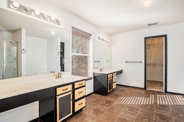 bathroom with vanity and a shower with shower door