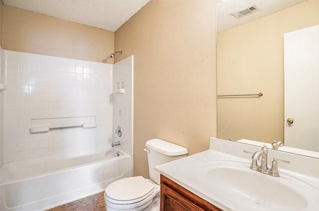 full bathroom featuring vanity, toilet, shower / bathing tub combination, and a textured ceiling