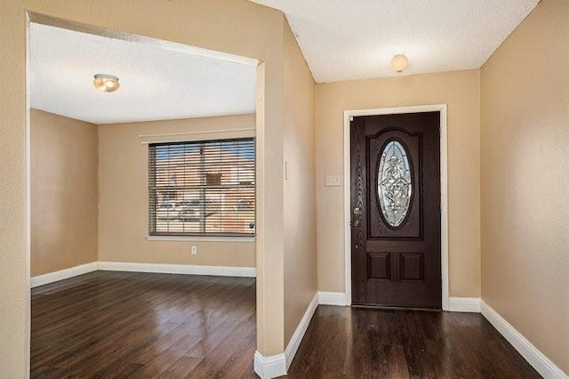 foyer featuring a textured ceiling and dark hardwood / wood-style flooring