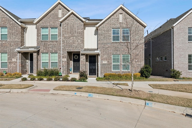 townhome / multi-family property featuring board and batten siding and brick siding