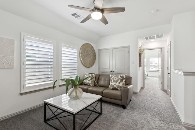 carpeted living room with ceiling fan and lofted ceiling