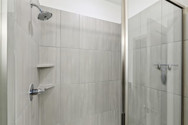 bathroom with a shower with shower door