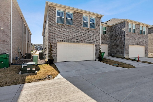 view of front property featuring central air condition unit and a garage