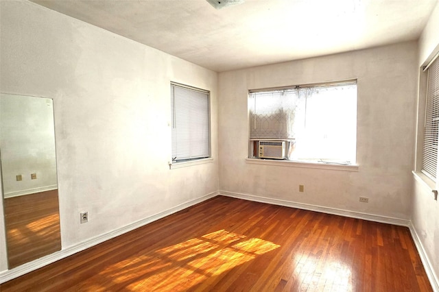 unfurnished room featuring cooling unit and dark wood-type flooring