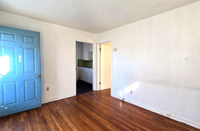 empty room with dark wood-type flooring