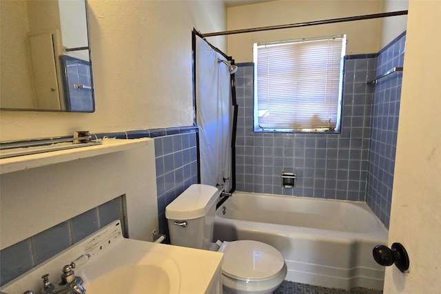 full bathroom featuring tile walls, tiled shower / bath combo, toilet, and vanity