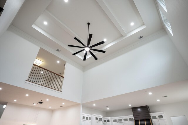 unfurnished living room with a wealth of natural light, built in features, a fireplace, a high ceiling, and light wood-type flooring