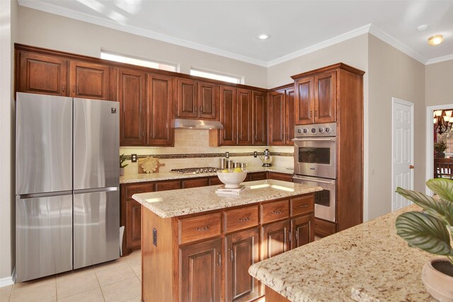 kitchen featuring pendant lighting, stainless steel appliances, light stone counters, ornamental molding, and kitchen peninsula