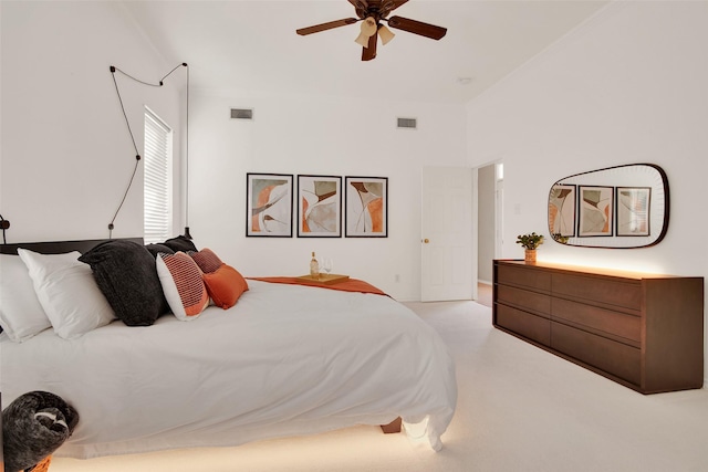 carpeted bedroom with ceiling fan and visible vents