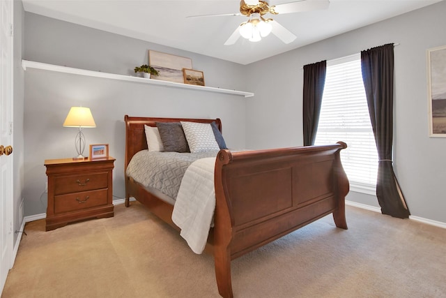 bedroom featuring light carpet, ceiling fan, and baseboards