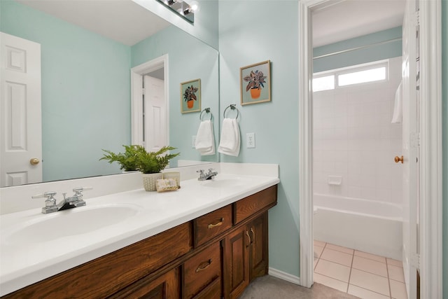 bathroom with double vanity, bathtub / shower combination, a sink, and tile patterned floors