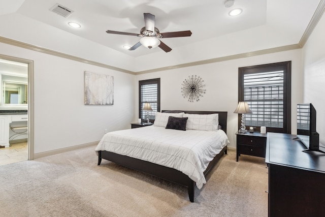 carpeted bedroom with ceiling fan and a raised ceiling