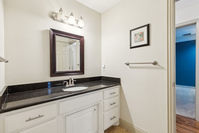 bathroom with hardwood / wood-style floors and vanity