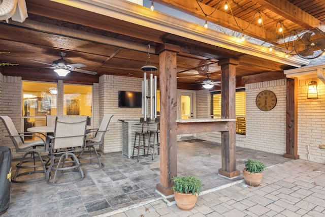 view of patio featuring ceiling fan and an outdoor bar