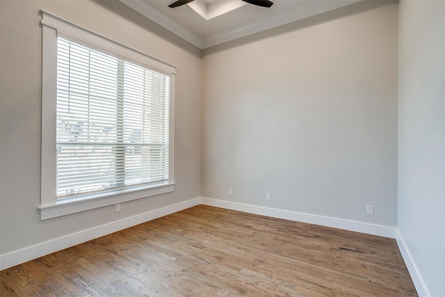 empty room featuring baseboards, ceiling fan, ornamental molding, and light wood-style floors