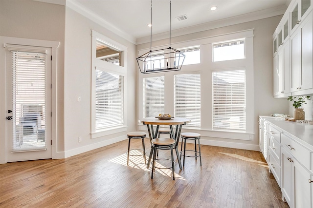 bedroom featuring light hardwood / wood-style flooring, a tray ceiling, ceiling fan, and ornamental molding