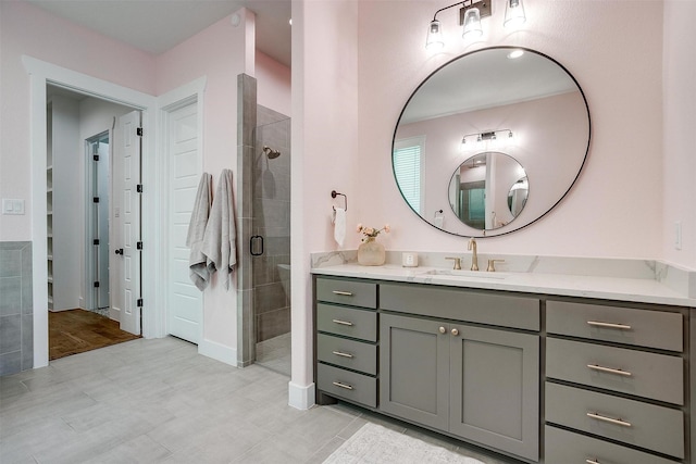 bathroom with a stall shower and vanity