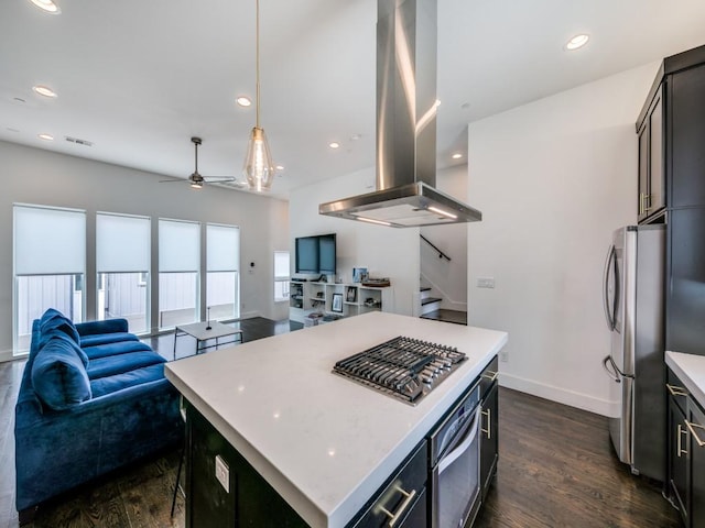 kitchen with island range hood, hanging light fixtures, a center island, stainless steel appliances, and ceiling fan