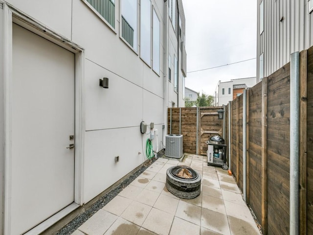 view of patio / terrace with central AC and an outdoor fire pit