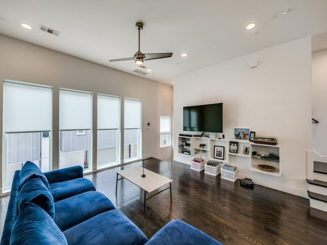 living room with ceiling fan and dark hardwood / wood-style floors