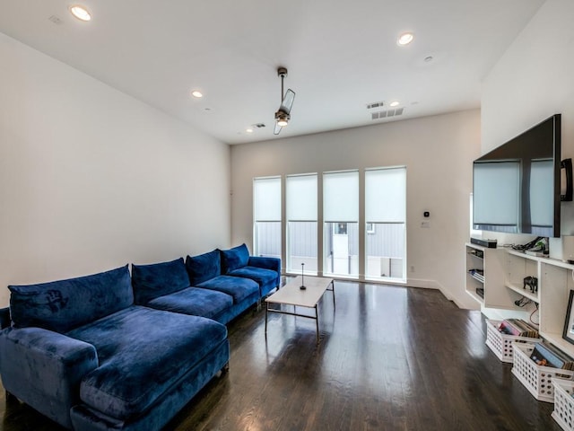 living room with ceiling fan and dark hardwood / wood-style floors