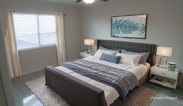 bedroom with ceiling fan and dark wood-type flooring