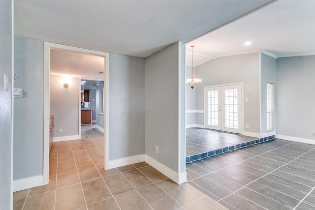 unfurnished room with tile patterned flooring, french doors, an inviting chandelier, ornamental molding, and vaulted ceiling