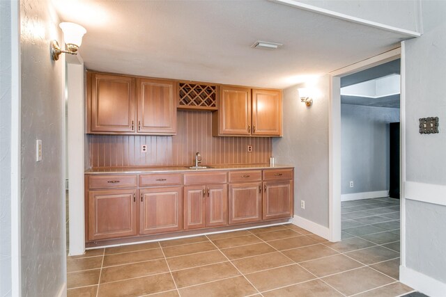 kitchen with light tile patterned floors and sink