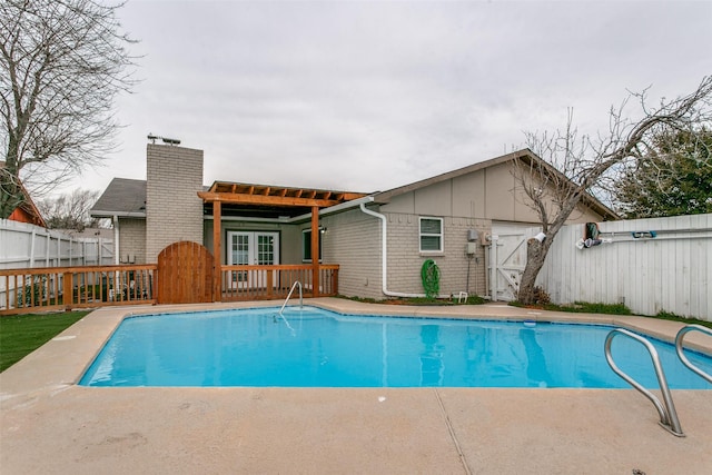 view of pool with a wooden deck and french doors