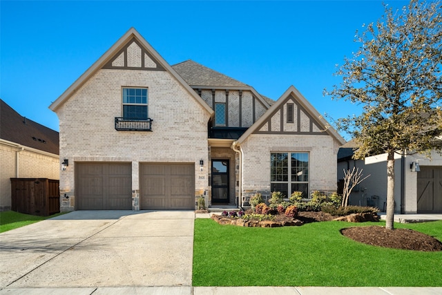 tudor-style house with a front yard and a garage