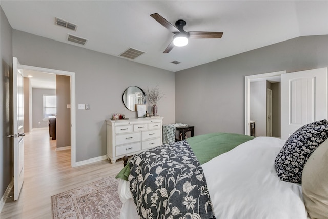 bedroom with lofted ceiling, ceiling fan, and light wood-type flooring