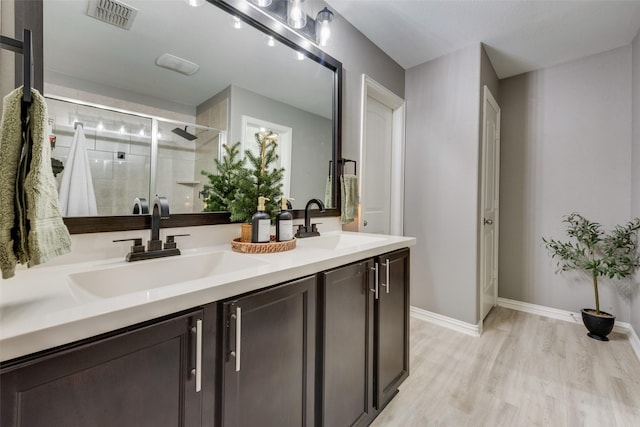 bathroom featuring vanity, a shower with shower door, and hardwood / wood-style flooring